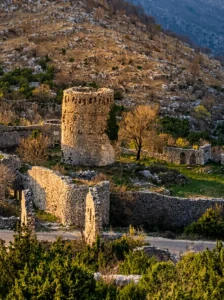 Stone remains of the tower and walls of the Old Town Hutovo set in a rugged Herzegovinian landscape