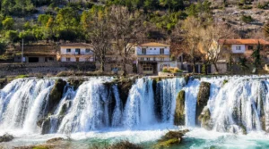 Provalije Waterfall with buildings in the background