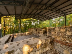 Stone remains of historical walls covered by a shelter at the Zidine site in Gornja Skakava