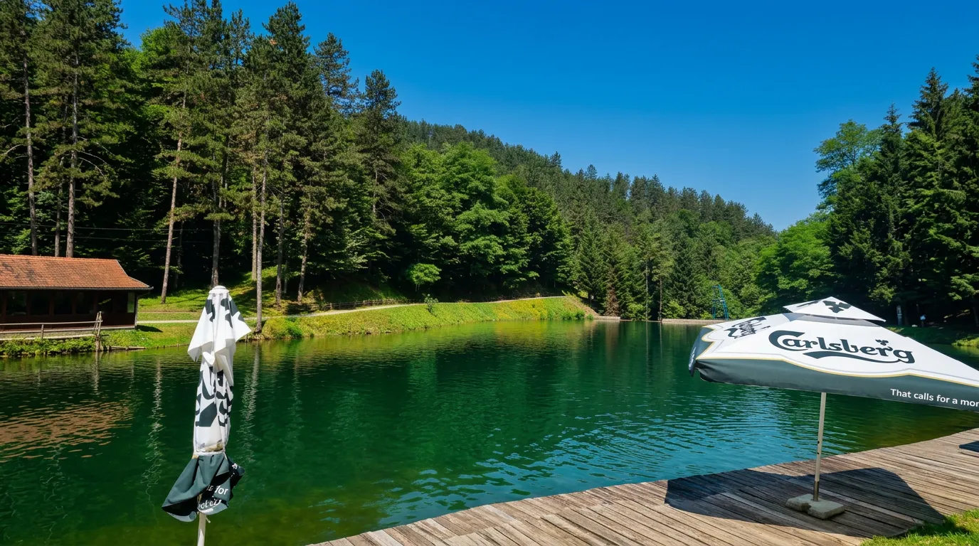A wooden pier and the clear green water of Goransko Lake on a sunny day