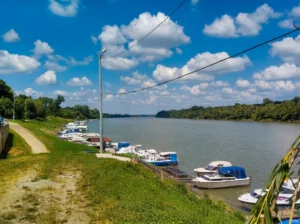 View of the river, pier, and moored boats at Ficbajer Picnic Area