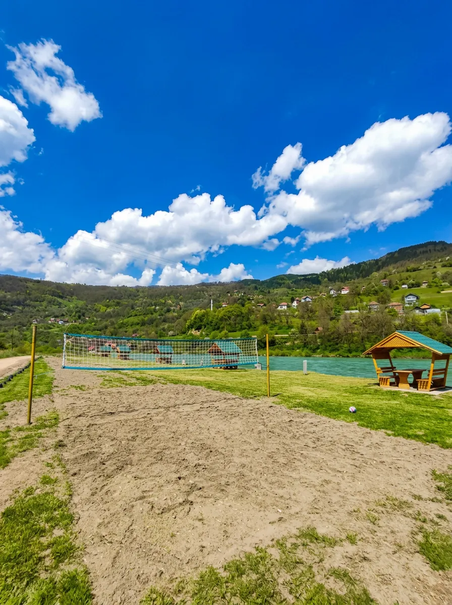 Sand sports court and wooden gazebos at the Sadba-Val excursion site