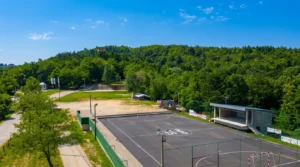 An open sports field surrounded by forest at Vis picnic area