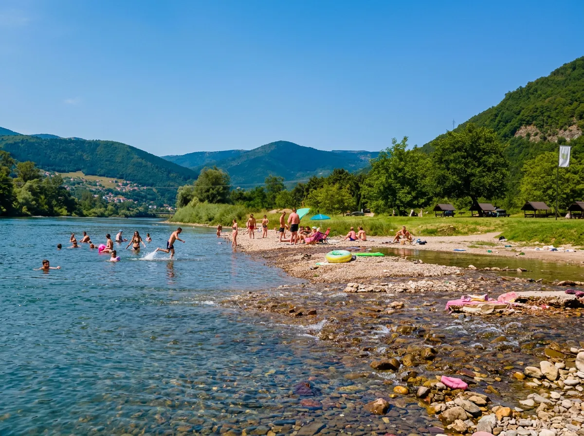 Bathers on the pebbly riverbank at the Zelena excursion site in Goražde