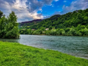 View of the calm river flow and green riverbank at the Zelena excursion site