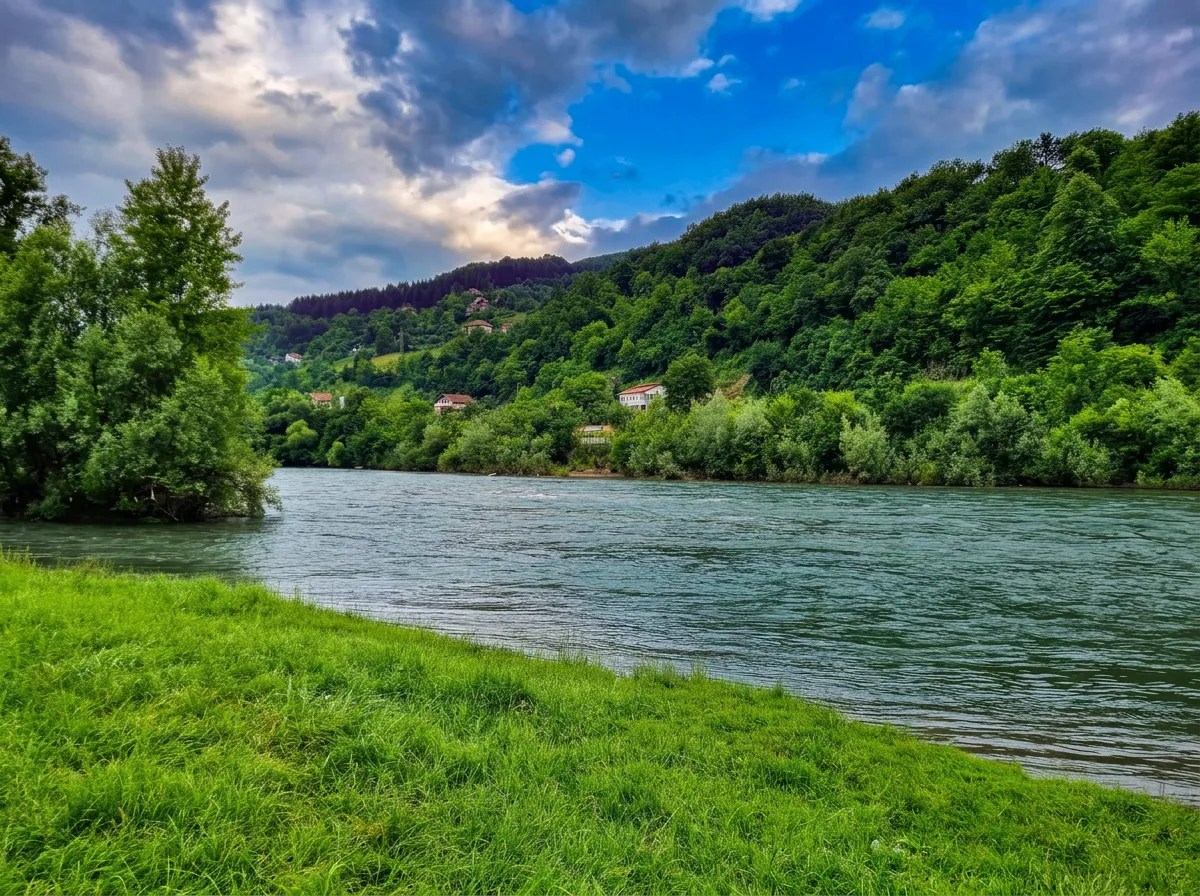 View of the calm river flow and green riverbank at the Zelena excursion site