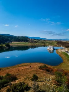 View of the open water and landscape of Hrast Lake on a sunny day
