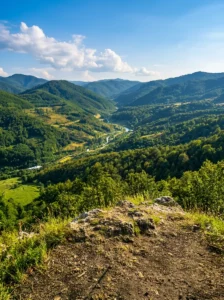 View of the valley and wooded peaks from a rocky viewpoint on Majevica mountain
