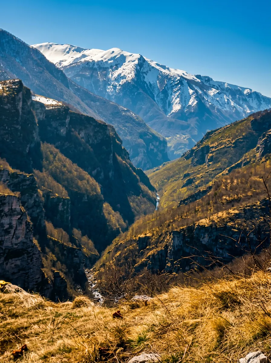 Deep, steep, and rugged canyon of the Rakitnica River with a view of the high, snow-covered mountain peaks of Visočica in the background