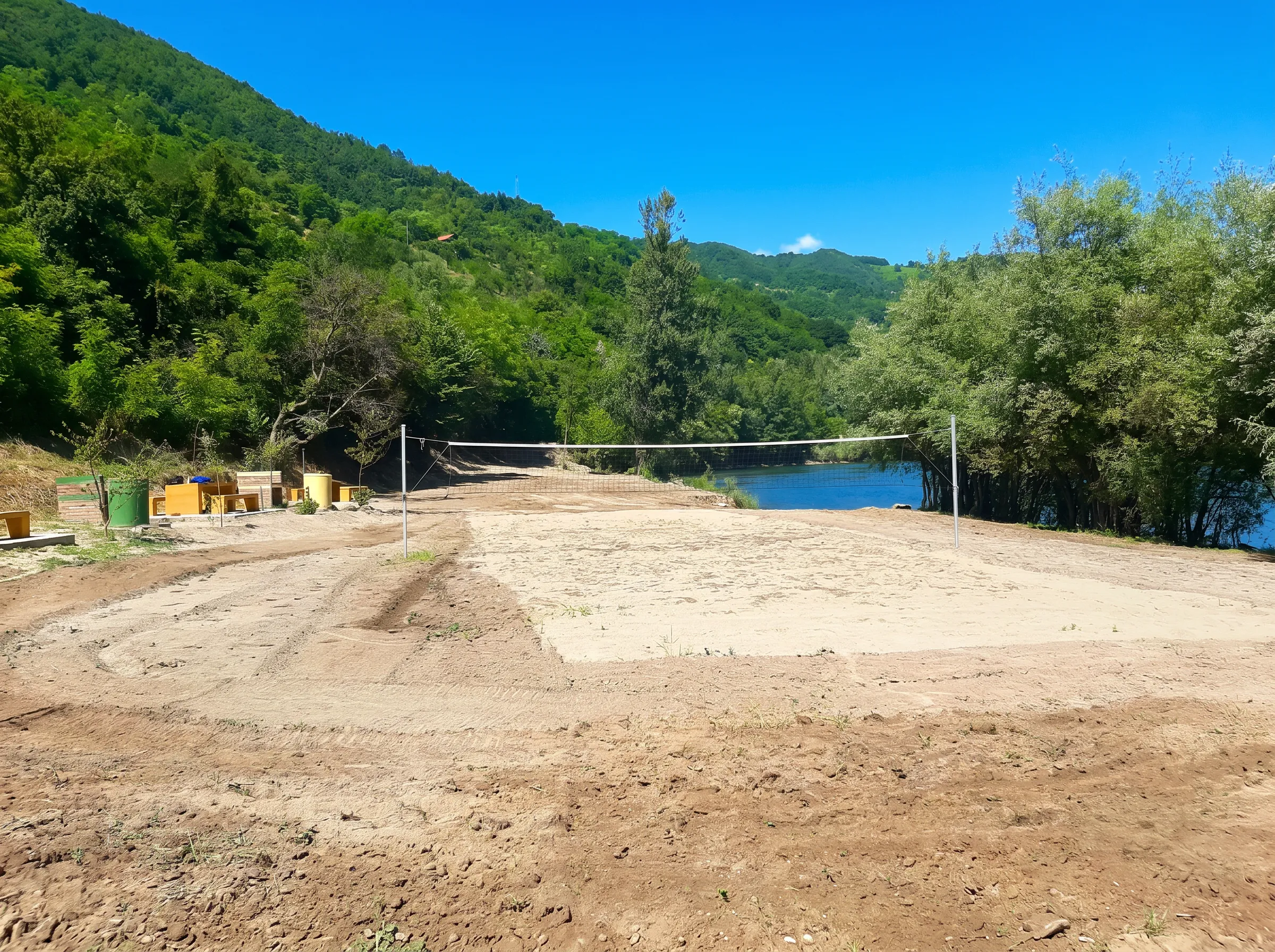 A sandy volleyball court at Desetka beach by the river