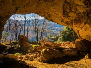 View from deep inside Ravlića Cave toward the wooded surroundings