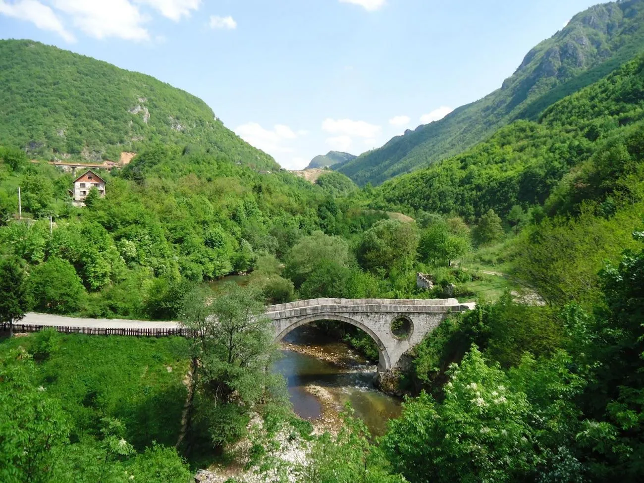 Kozija ćuprija u Sarajevu, stari kameni most sa lukovima okružen zelenim šumama